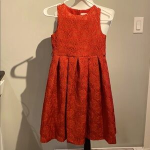 Girls fancy red dress. Gold rose  patterned.